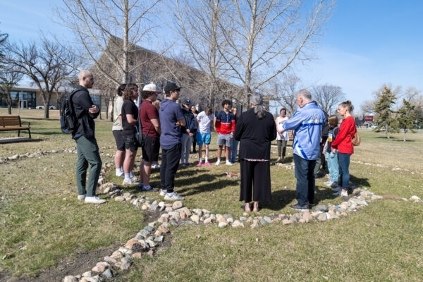 Group gathered outdoors for an educational activity.