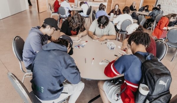 Students seated at tables during an educational activity.