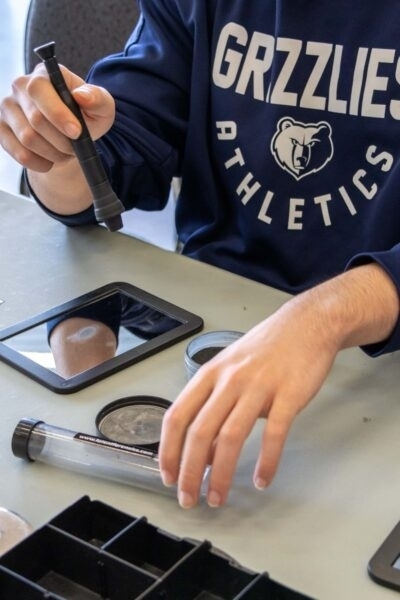 Student using forensic tools during an educational activity.